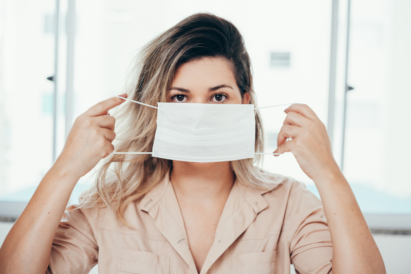 Cosmetic Solutions Covid Webinar Image features a female holding a mask over her face